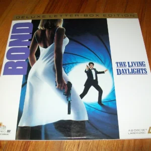James Bond in a white dress holding a gun, with a man in a tuxedo in the background.
